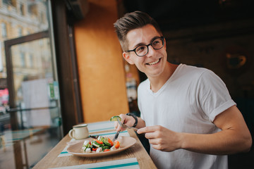 Young man eating a healthy salad