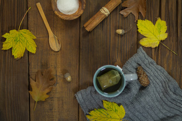 Hot tea on rustic background in the autumn ambiance
