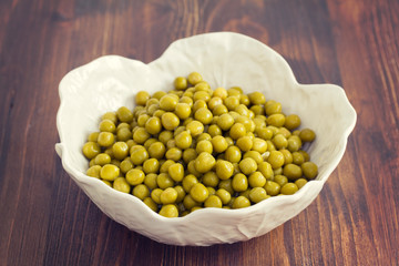 boiled peas on white bowl on white background