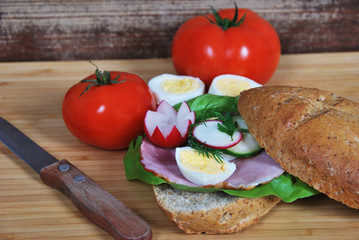 sandwich with radish ham and egg and cucumber salad for breakfast