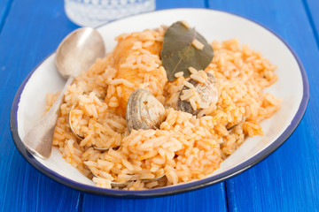 rice with seafood and fish on dish