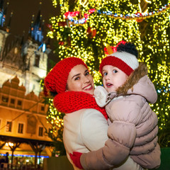 smiling mother and child tourists at Christmas in Prague