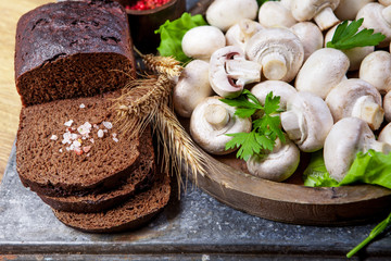 Fresh champignon mushrooms on wooden table