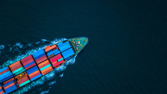 Aerial view from drone, Container ship or cargo shipping business logistic import and export freight transportation by container ship in open sea, Container loading cargo freight ship boat.