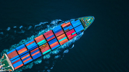 Aerial view container ship or cargo ship in deep blue sea water import export and business logistic.
