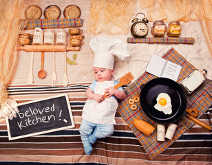 Infant cook baby boy portrait wearing apron and chef hat
