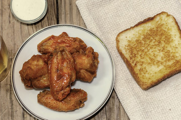 buffalo hot wings on wooden background