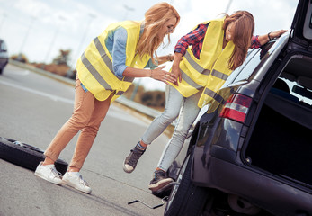 Fototapeta premium Girls having a problem with a car