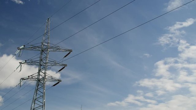 Electrical Transmission Tower And Power Lines Time lapse Clouds run over High-voltage transmission line