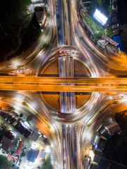 The light on the road roundabout at night and the city in Bangkok, Thailand. Aerial view. Top view. Background scenic road.