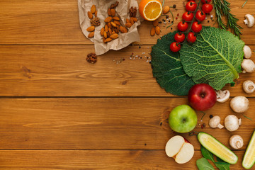 Border of fresh vegetables on wooden background with copy space