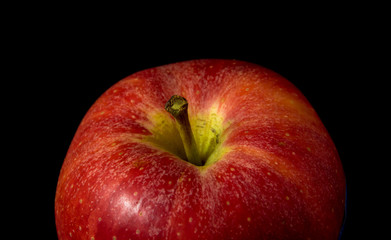the red apple on black background