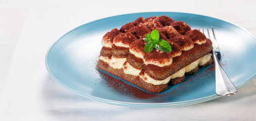 Tiramisu, traditional Italian dessert on a plate