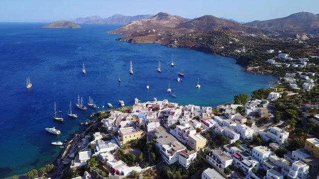 August 2017: Aerial drone video from picturesque village of Panteli with view to iconic fortified castle and windmills uphill, Leros island, Dodecanese, Greece