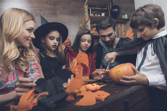 Happy Family Carves Decorative Bats From Paper For A Halloween Party