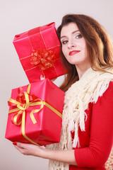 Woman holds red christmas gift boxes