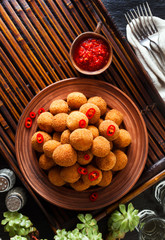Fried Arancini rice balls . Typical Sicilian street food with spicy sauce