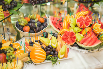 Various sweet sliced fruit on a buffet table