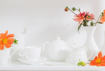white dishware with flowers on wooden shelf