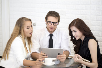 Businessman using Tablet for working at Cafe with team, People have a Meeting together at Cafe, People working concept