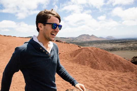 Cheerful man walking against of mountains