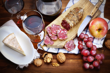 Salami, cheese, grapes, apple, walnuts and red wine