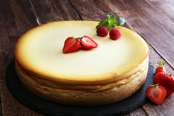 Homemade cheesecake with fresh strawberries and mint for dessert - healthy organic summer dessert pie cheesecake. Vanilla Cheese Cake.
