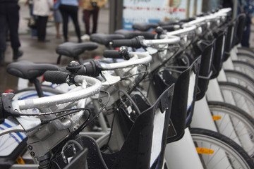 Fototapeta premium Seat of bicycle at the bike parking lot. Take bicycles for rent cheap and ride the city streets safe. Healthy urban transportation