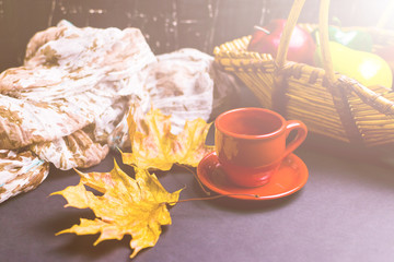Cup of tea surrounded by autumn leaves. Autumn concept
