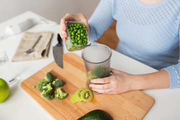 woman hand adding pea to measuring cup