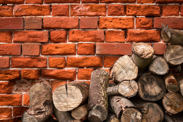 Logs on the background of a brick wall