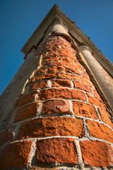 Old column of an abandoned Palace. Cracked concrete vintage brick wall background.