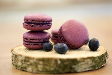 blueberry macarons on wooden stand