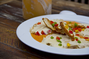 Breaded chicken slices and cheese sauce