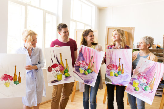 group of artists with pictures at art school