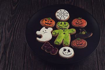 Homemade delicious ginger biscuits for Halloween on wooden table