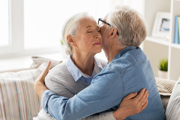 happy senior couple hugging at home