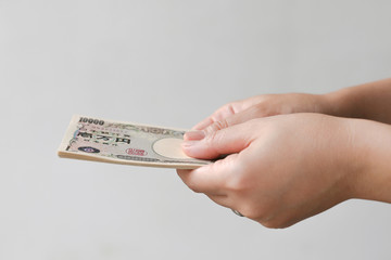 Hand Holding Japanese Currency (Yen) isolated
