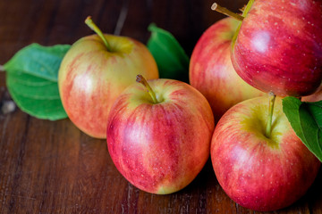 Ripe red apples on wooden background
