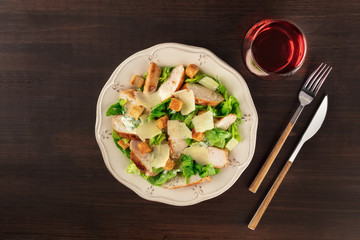 Chicken Caesar salad and wine with copy space