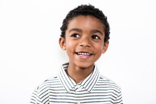 Portrait of a happy little boy over white background.