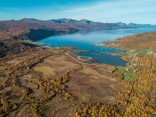 Aerial drone view of norwegian fjord surrounded by mountains and autumn nature, Dåfjord (Dafjord)...
