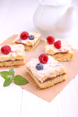 Obraz na płótnie Canvas Homemade pie with berries cut into slices on a white background