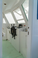 Steering wheel on an old yacht. Captain's cabin