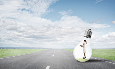 Businesswoman inside light bulb