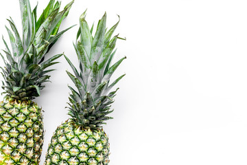 Tropical fruits background. Pinneapple on white top view copyspace