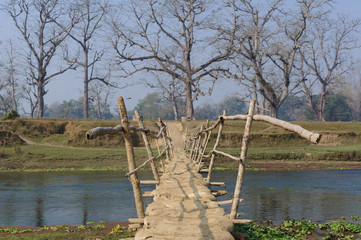 Wooden bridge in village in Nepal A bridge across the River Rapti, in the Chitwan National Park. Nepal