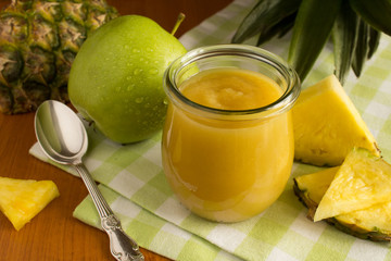 Puree with pineapple and apple on the green napkin