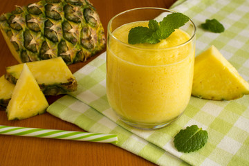 Smoothie with pineapple on the green napkin