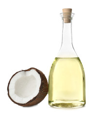 Bottle with fresh coconut oil and nut on white background © Africa Studio
